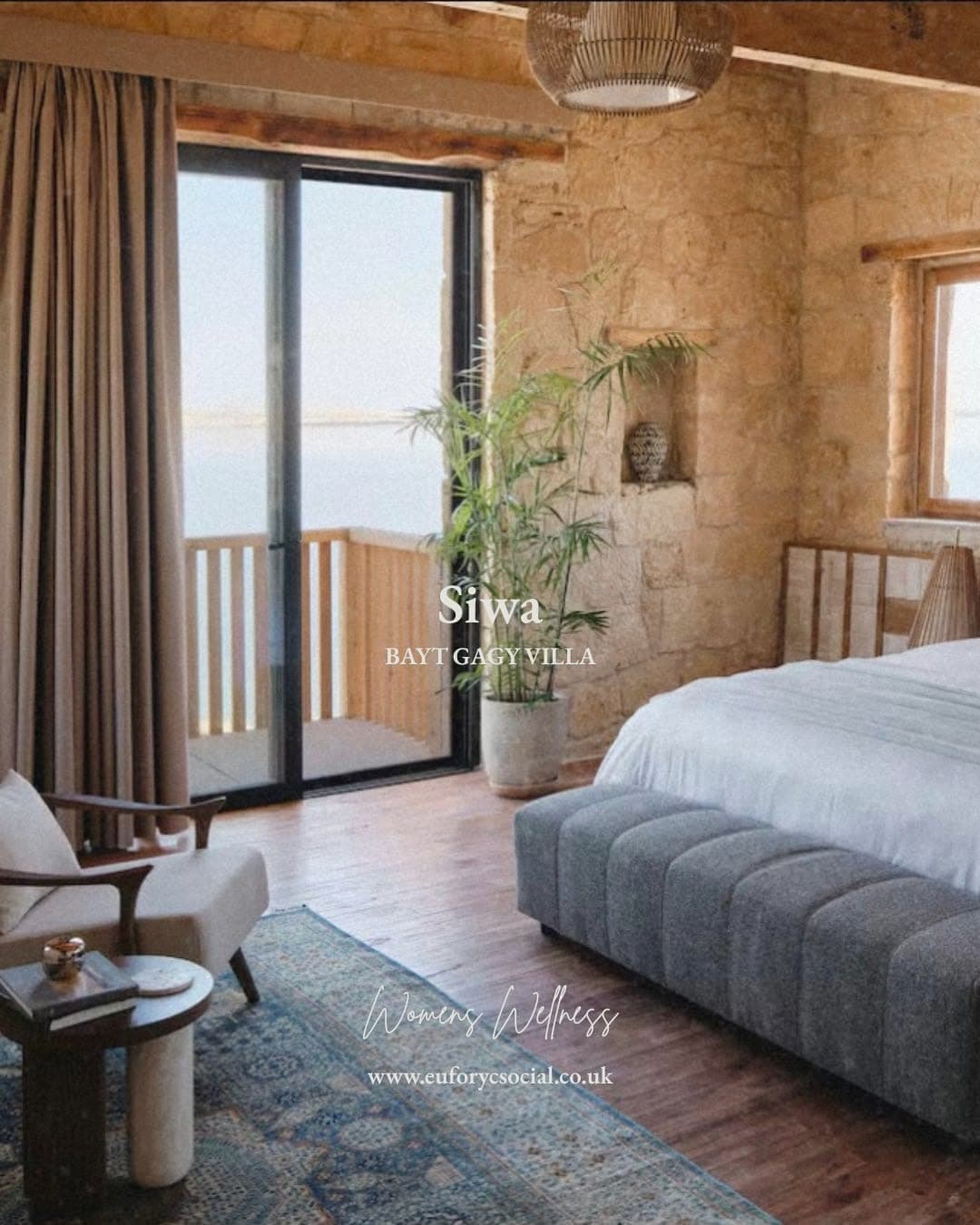 A bedroom at Bayt Gagy Villa opening onto a balcony over the lake